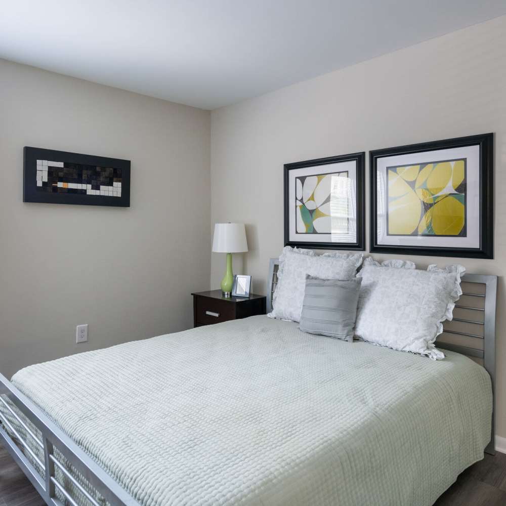 Cozy bedroom with a bed and windows at Woodmere Trace in Norfolk, Virginia