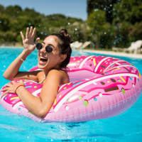Resident relaxing in outdoor swimming pool at Woodbrook in Gardendale, Alabama