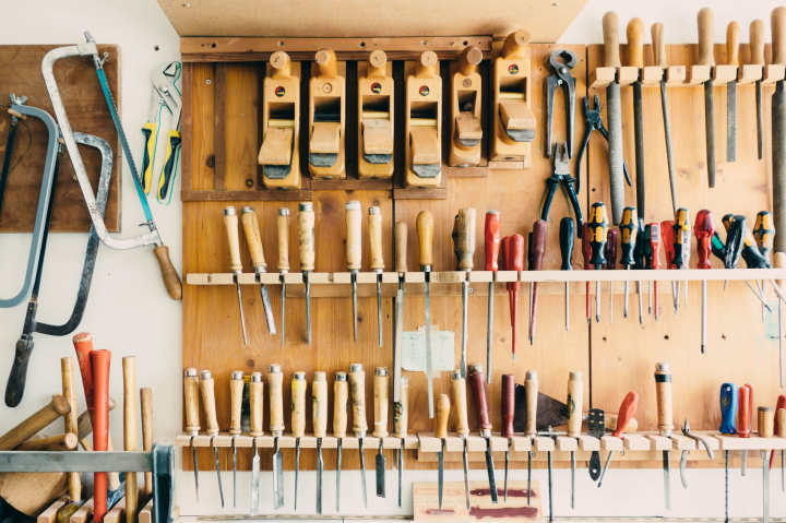 an organized wall of tools in a garage