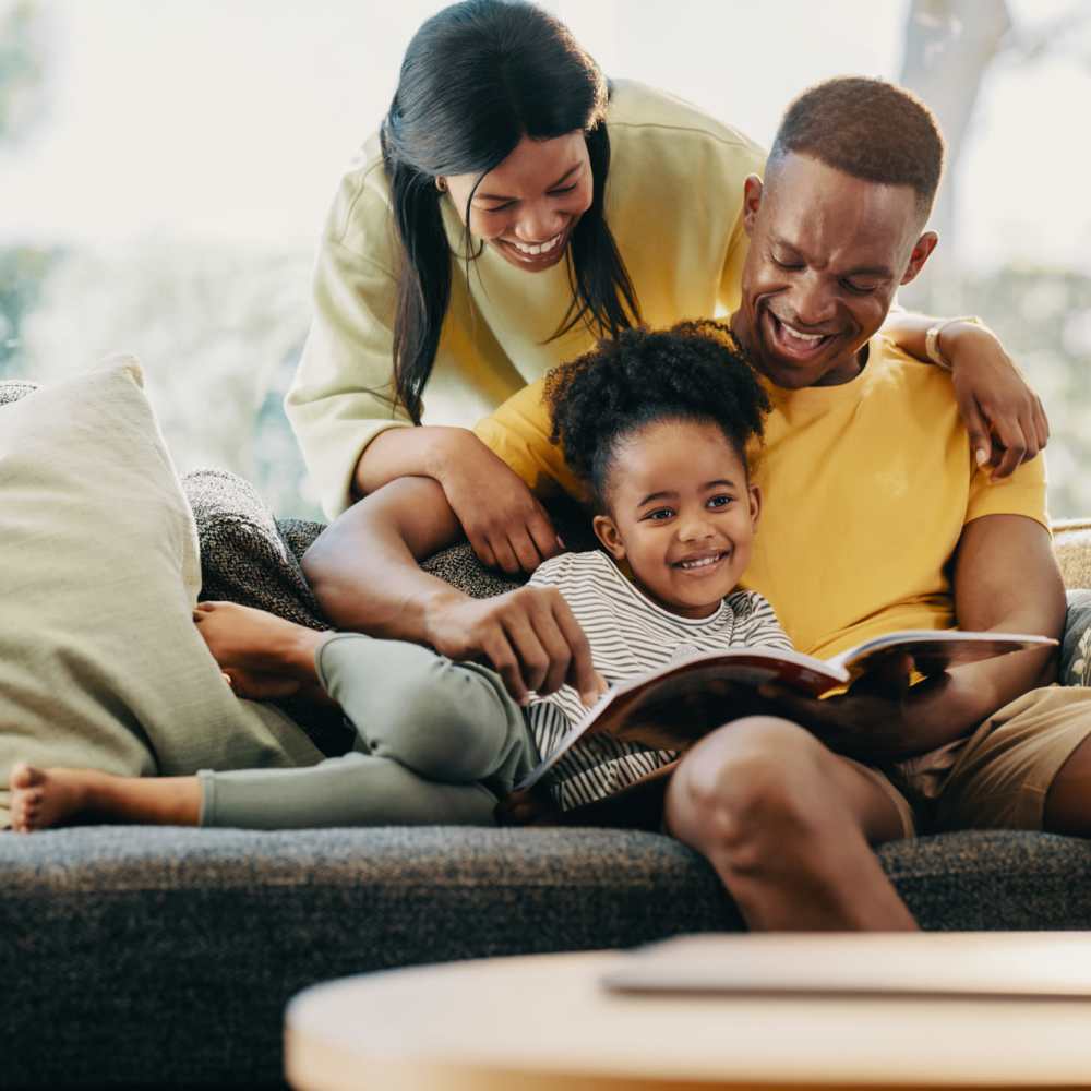 A happy family in living room at Westbury Apartments in Wayland, Michigan
