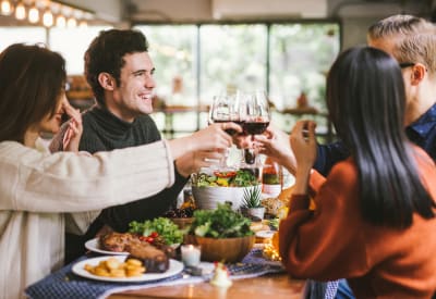 Resident friends out for a meal and drinks near Waterfield Court Apartment Homes in Aurora, Colorado