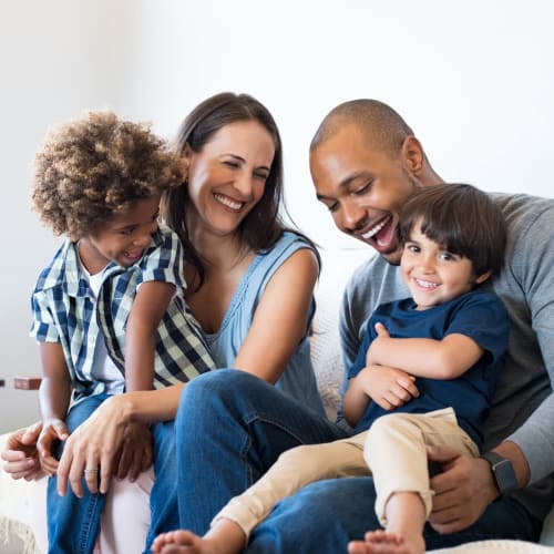 A family sitting on the couch at San Onofre I in San Clemente, California