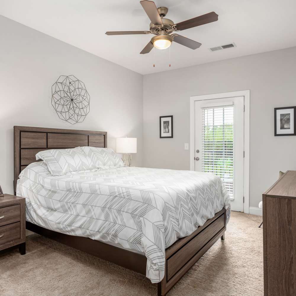 Bedroom With Bed And Door To Outside at Retreat at the Park in Burlington, North Carolina