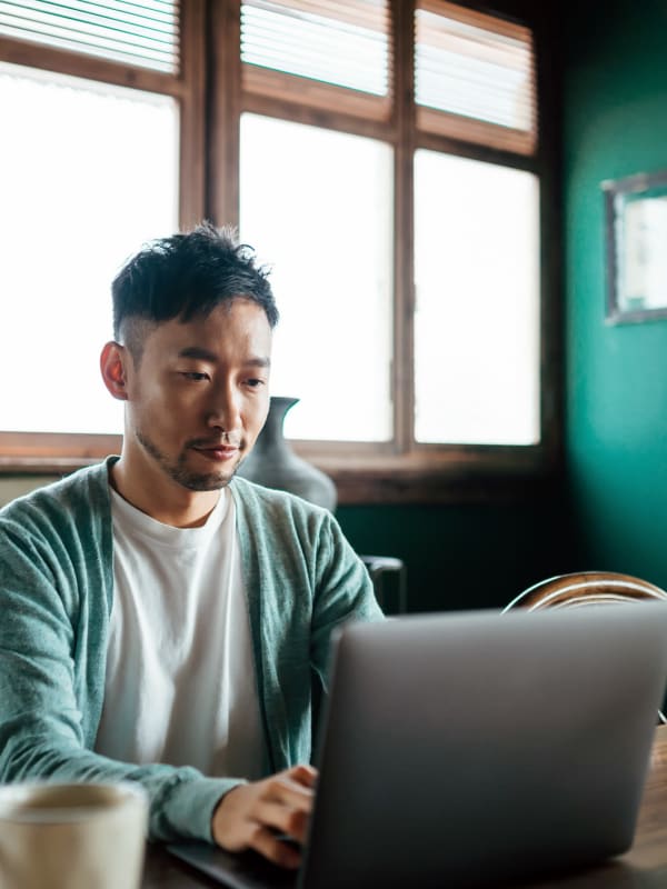 a resident working from his laptop near  Keizer Station Apartments in Keizer, Oregon