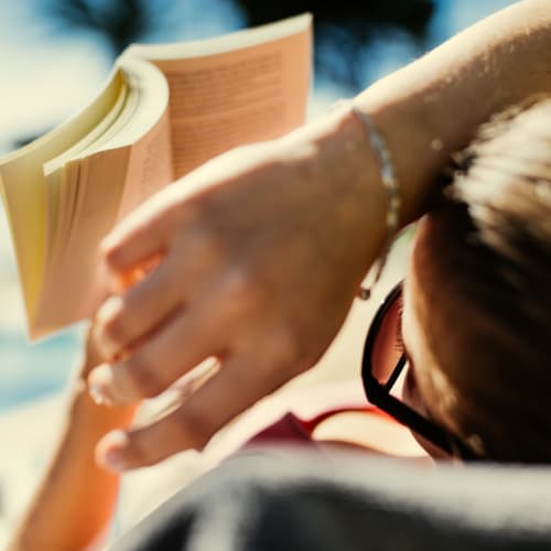 Resident reading at Solaire 7077 Woodmont in Bethesda, Maryland