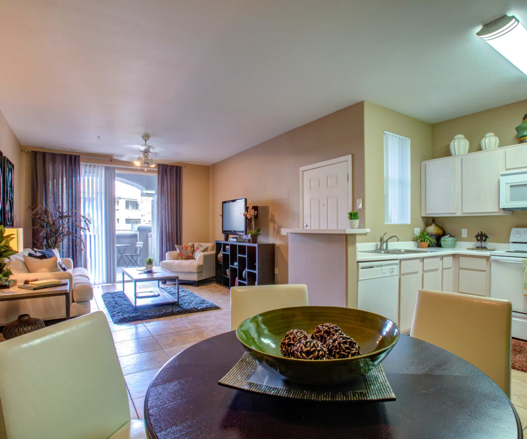 View of the living area and kitchen from a model home's dining room at Sierra Canyon in Glendale, Arizona