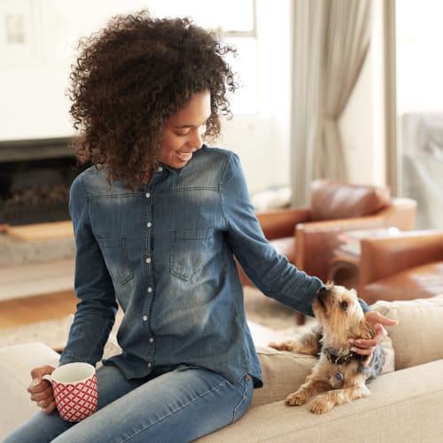 A resident playing with her dog at Seaside Village in Oceanside, California