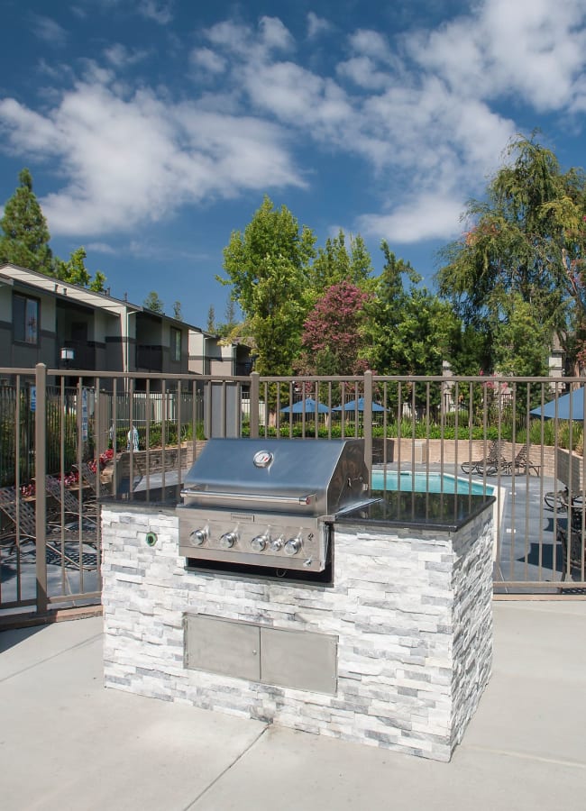 Poolside barbecue grill at dusk at Valley Ridge Apartment Homes in Martinez, California