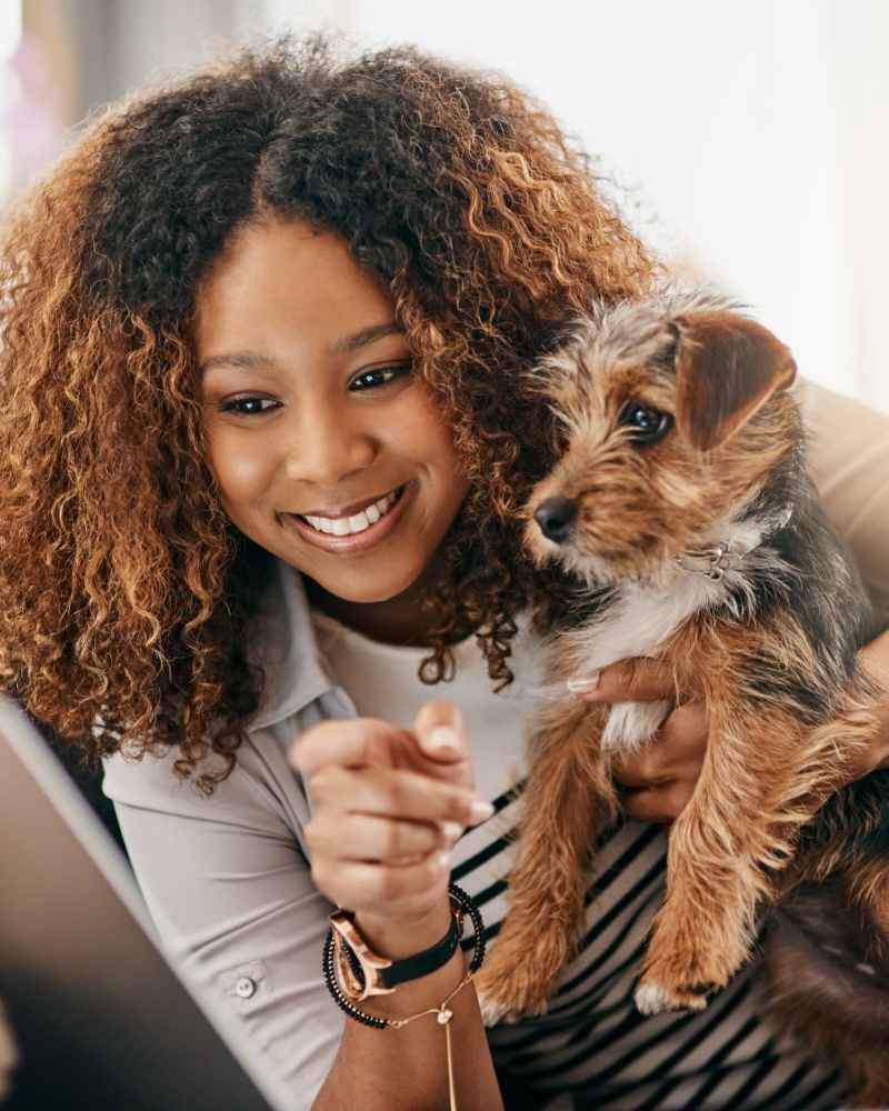 A resident with her pet dog at Solitair Brickell Apartments in Miami, Florida