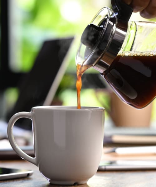 Resident pouring a cup of coffee at The Shockoe Collection in Richmond, Virginia