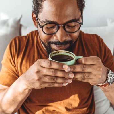 Resident drinking coffee at Campbell Run Apartments in Woodinville, Washington 