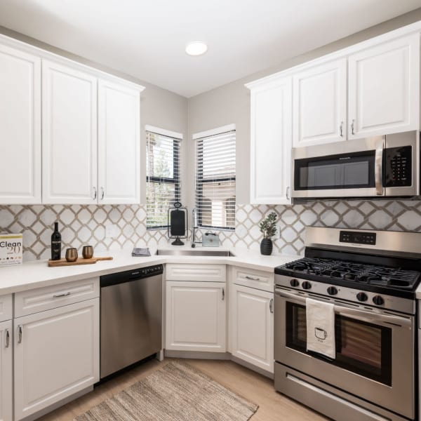 Gourmet kitchen with stainless-steel appliances and white cabinets at Ascend at Kierland in Scottsdale, Arizona