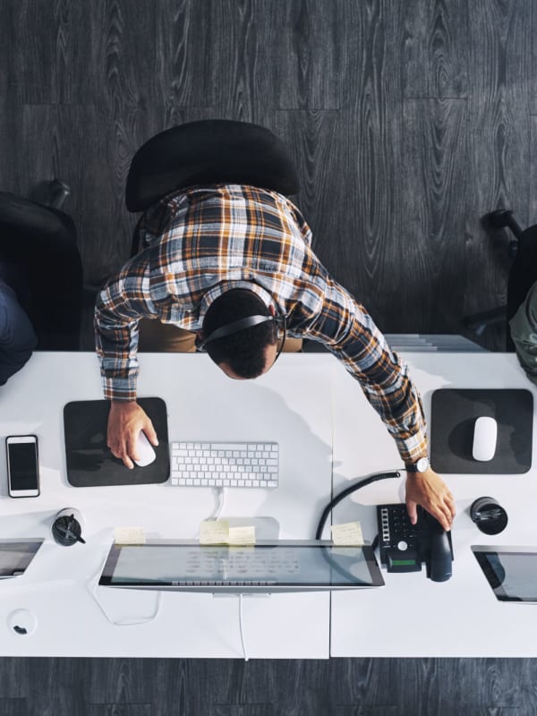 An employee at a desk at NextGen Properties in Costa Mesa, California