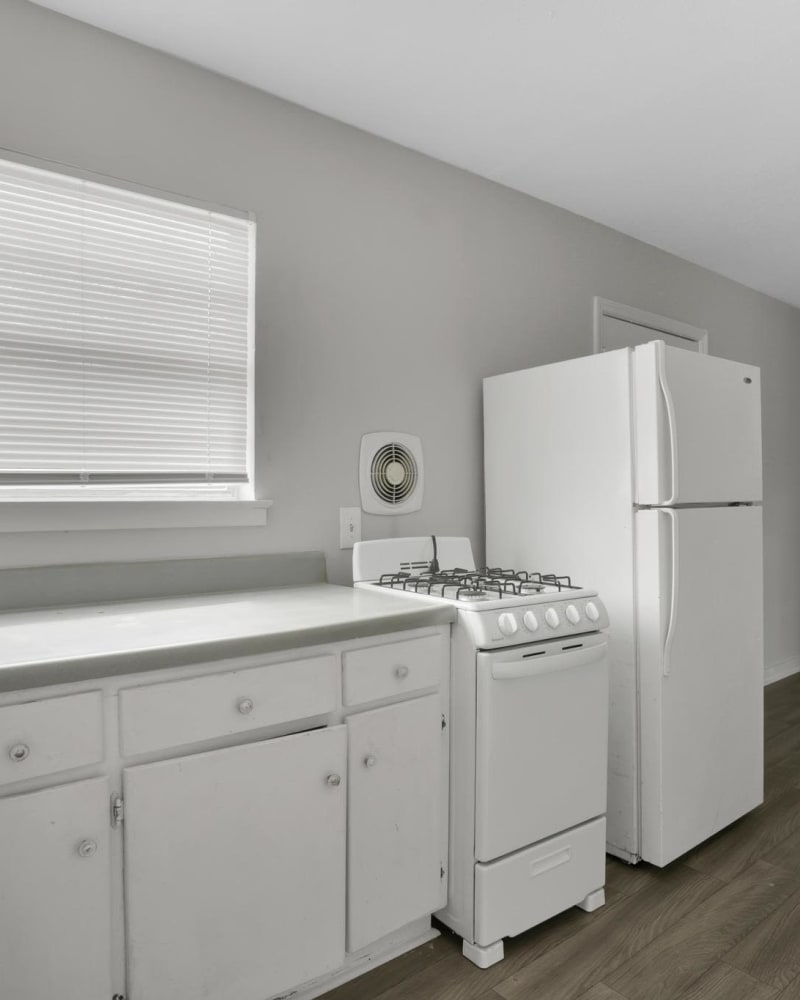 White cabinets in an apartment kitchen at Garrett Woods Apartment Homes in Phenix City, Alabama at dusk
