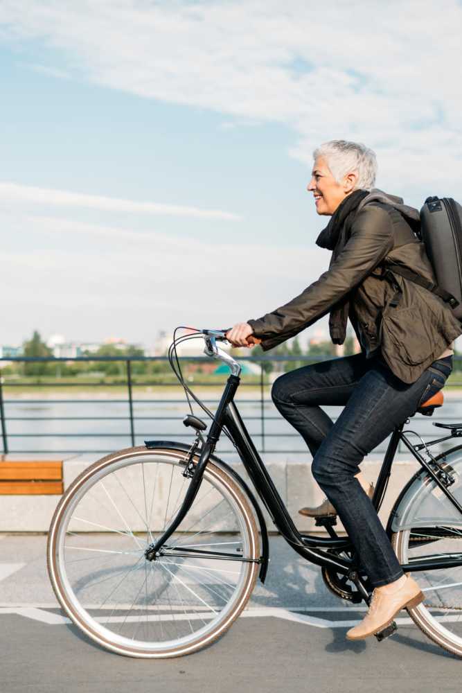 Resident going for a bike ride along the waterfront near Arcos in San Antonio, Texas