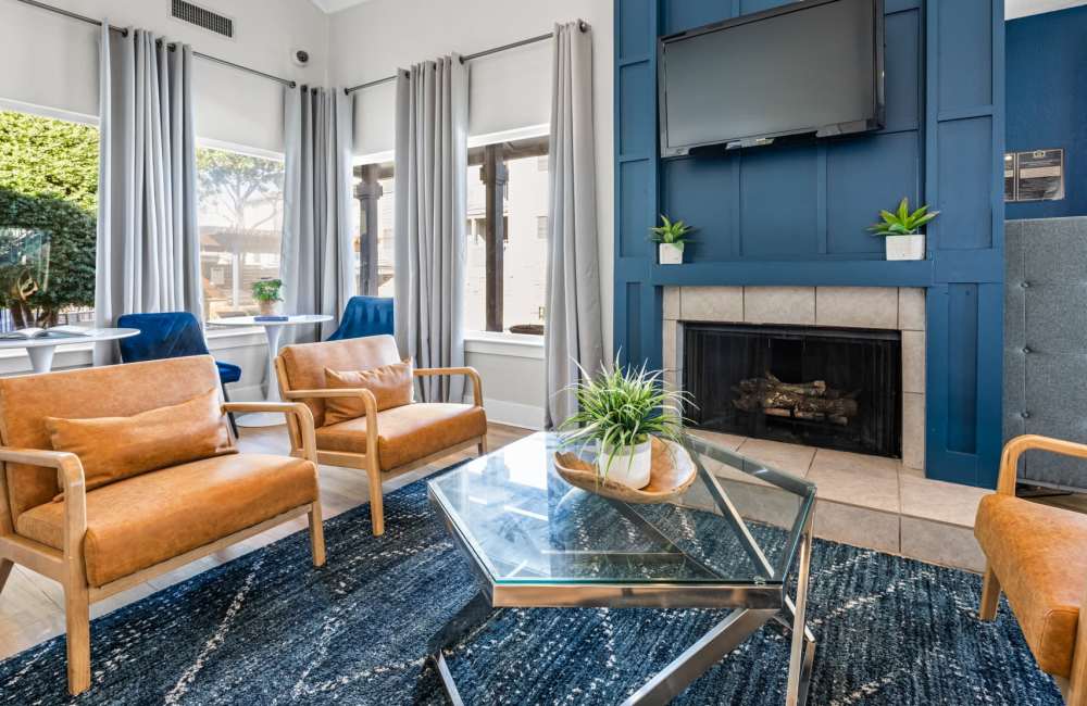 Clubhouse with chairs and a fireplace at 18Eleven Frankford in Carrollton,Texas