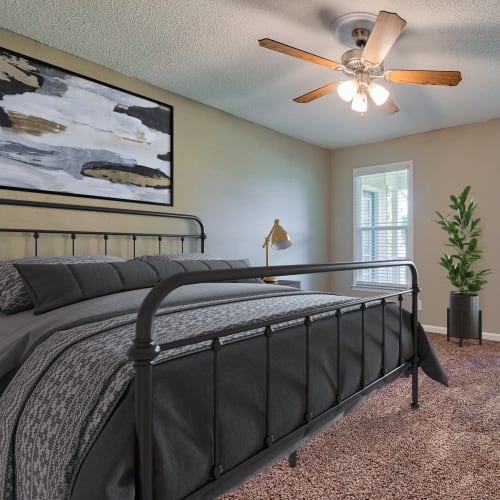 Bedroom with plush carpeting at The Gatsby at Midtown Apartment Living in Montgomery, Alabama