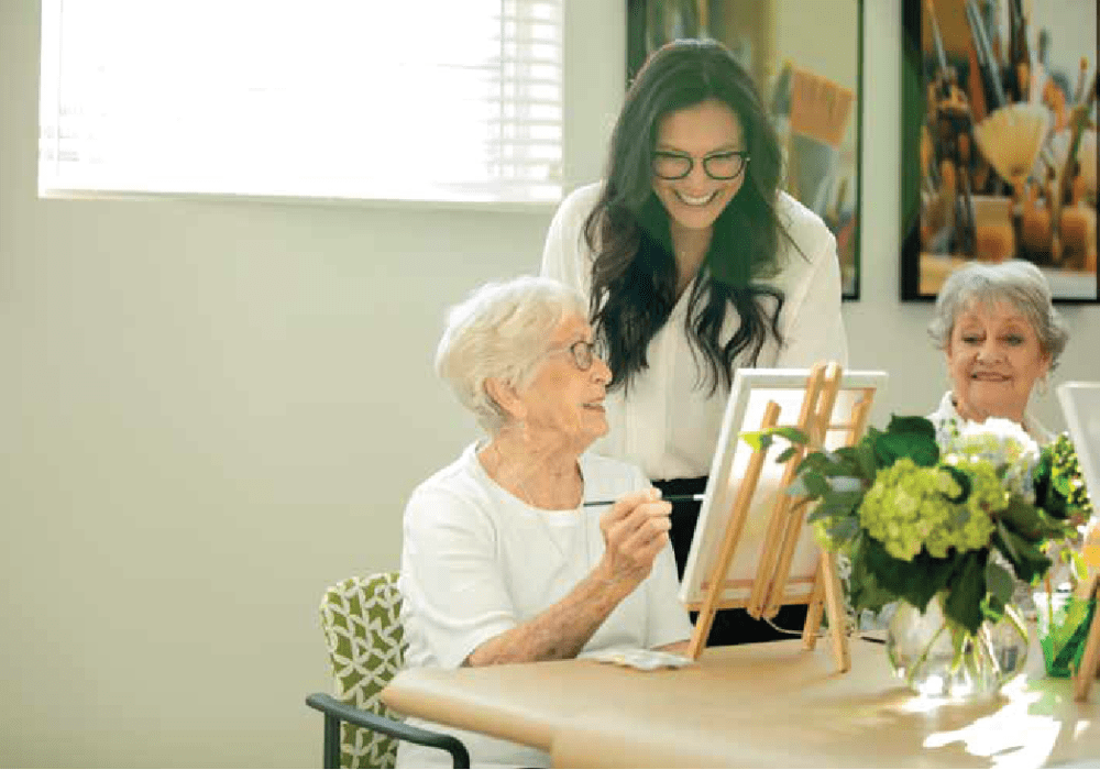 Resident and caregiver in a painting class at Clearwater at The Arboretum in Austin, Texas