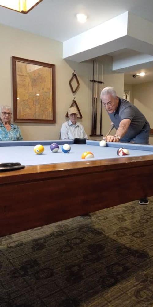 Resident playing pool at Arcadia Communities in Louisville, Kentucky
