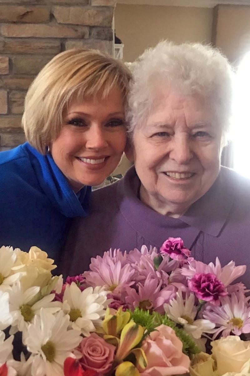 Resident and caregiver smiling together at Preston Place in Sherman, Texas