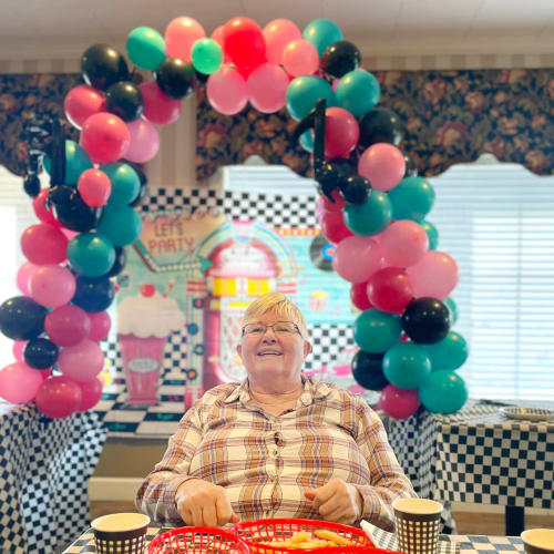 Group of residents having tea and biscuits at Saddlebrook Oxford Memory Care in Frisco, Texas