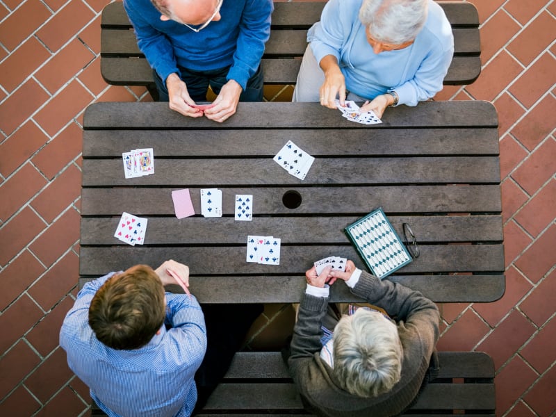 A group of elderly people playing card games at The Pillars of Hermantown in Hermantown, Minnesota