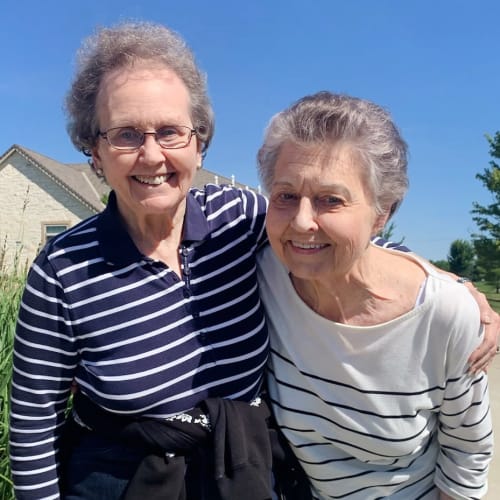 Resident friends taking a walk at Glen Carr House Memory Care in Derby, Kansas