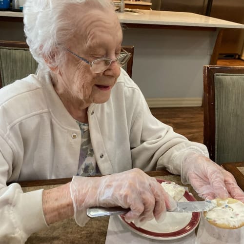 Resident partying with a drink in hand at Glen Carr House Memory Care in Derby, Kansas