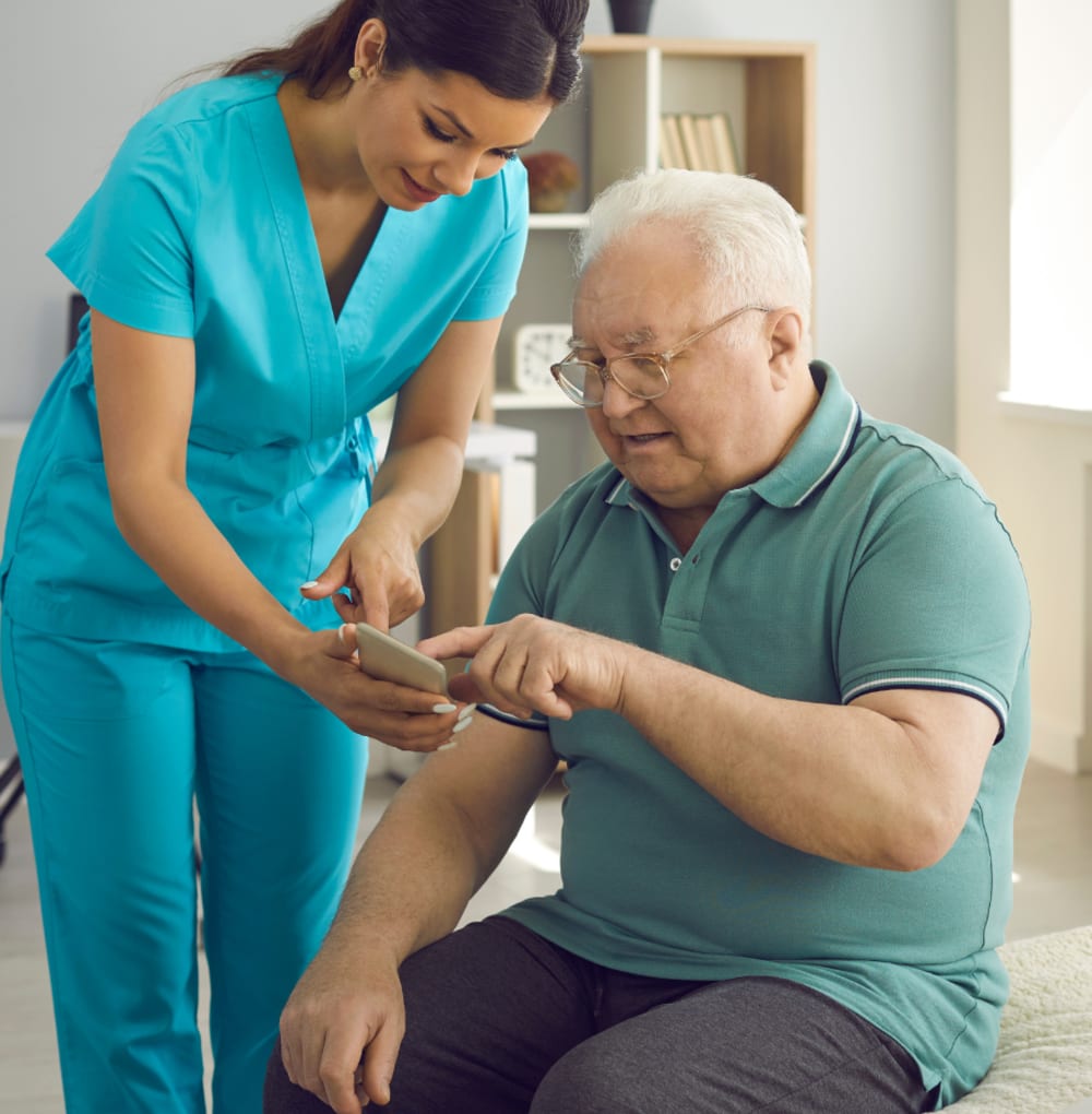 Resident sitting and talking to a caretaker at Blossom Ridge in Oakland Charter Township, Michigan