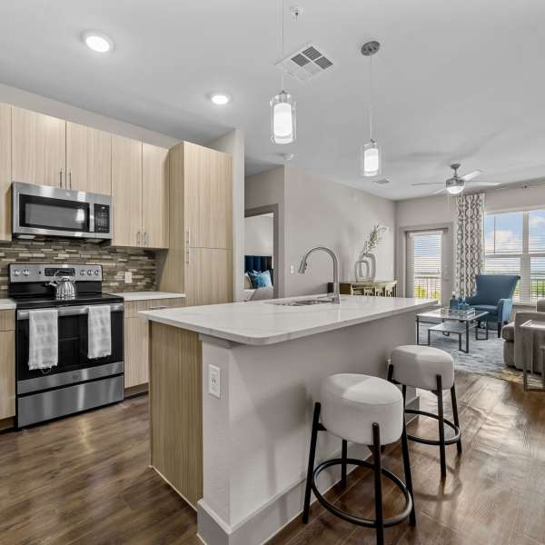 Open concept kitchen and living room in a home at Harbor Hill in Rockwall, Texas