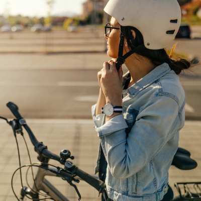 Resident putting on a helmet to bike near Millenium Cove in Orlando, Florida