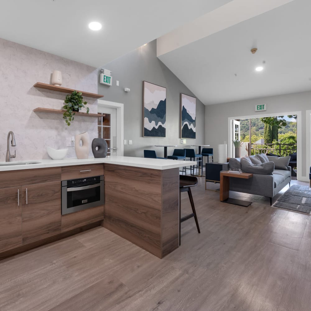 Elegant hardwood floors with kitchen and living room view at Town Center Apartments in Lafayette, California