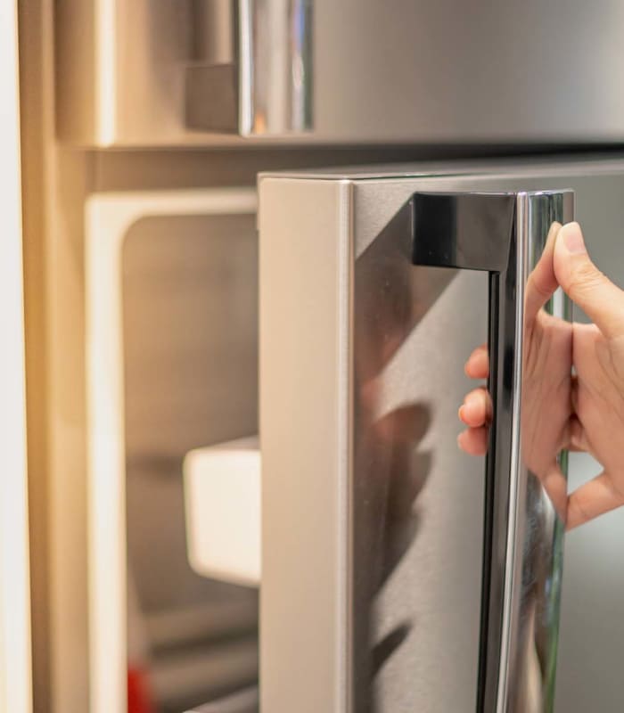 Stainless steel fridge with open door at Windsor Gardens Apartments in Rochester, New York