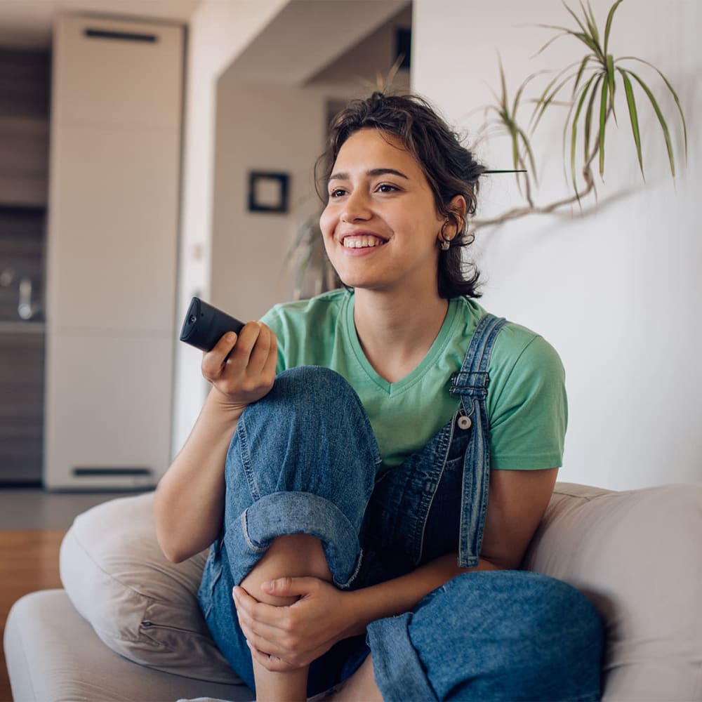 Resident relaxing with a good book on the couch in her new apartment at Mission Rock at North Bay in Novato, California