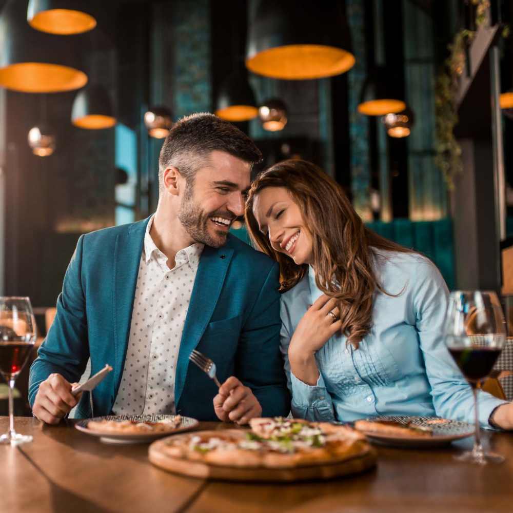 Happy couple having their food in a restaurant at Lodge at Lake Wylie in Lake Wylie, South Carolina