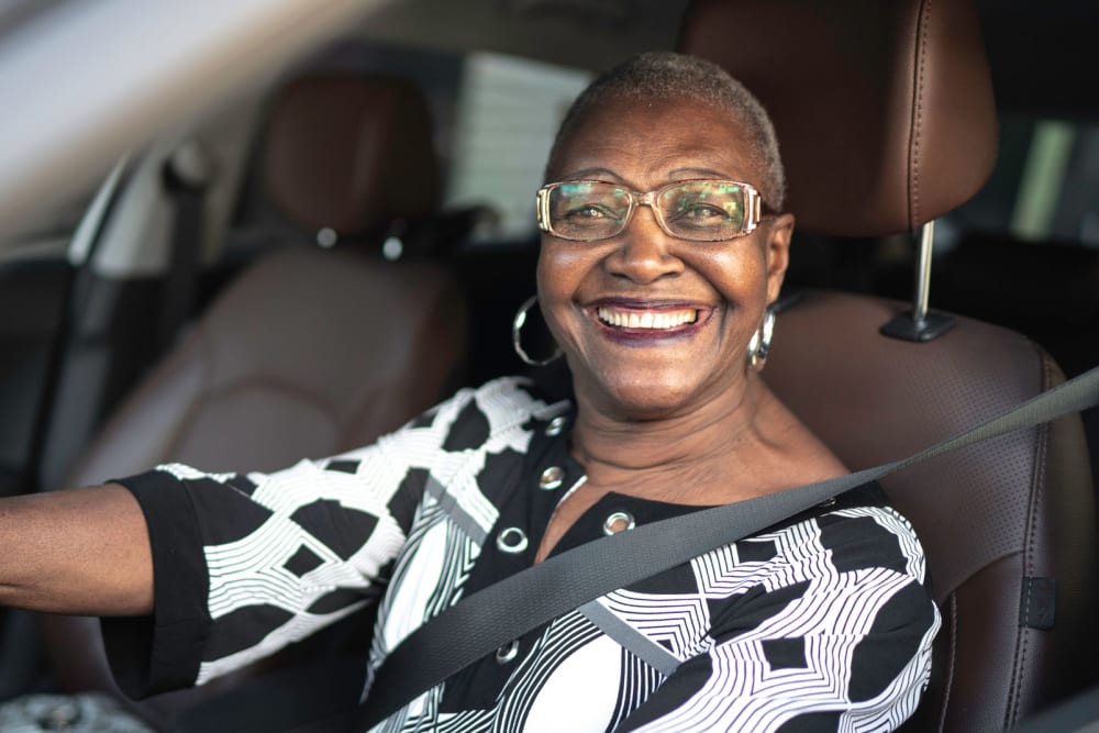 Resident sitting in her car ready to go on a trip near Campus Commons Senior Living in Sacramento, California