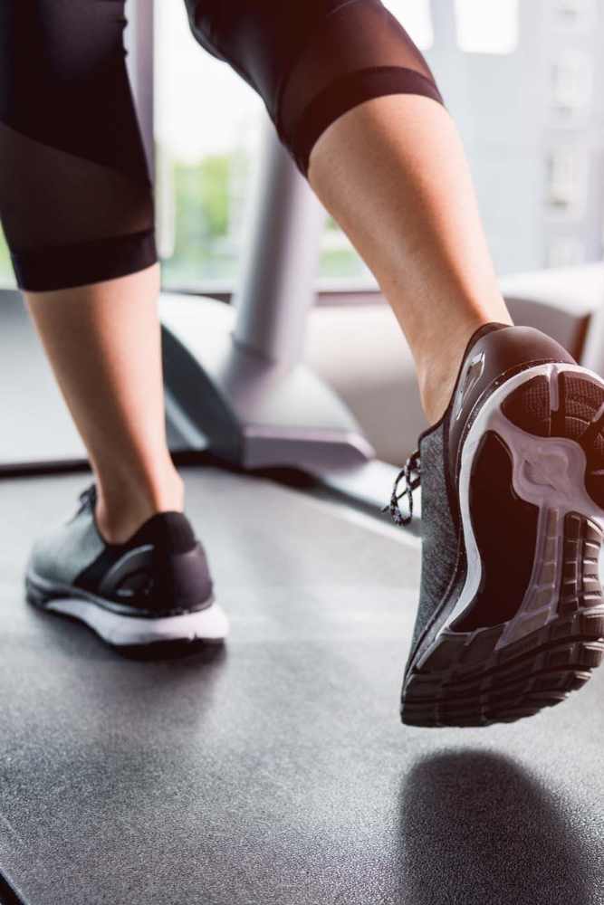 Resident exercising on a treadmill in the fitness center at Icon Apartments in San Antonio, Texas