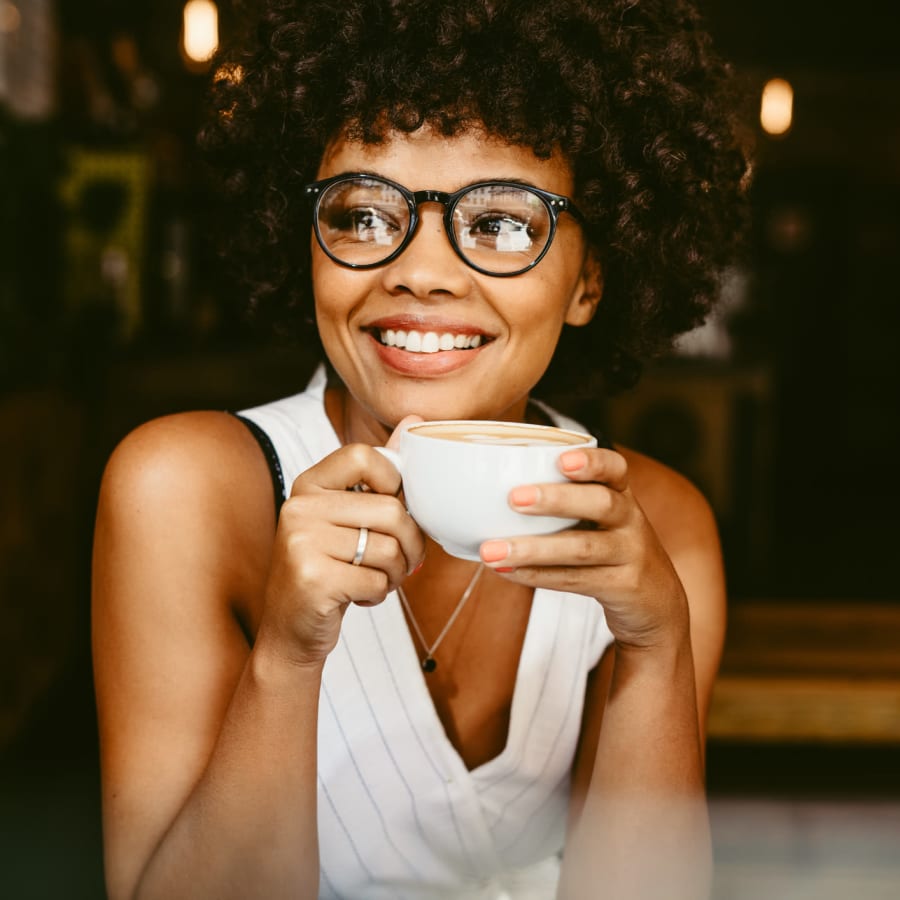 Young woman drinking coffee at Sedona Falls in Marietta, Georgia