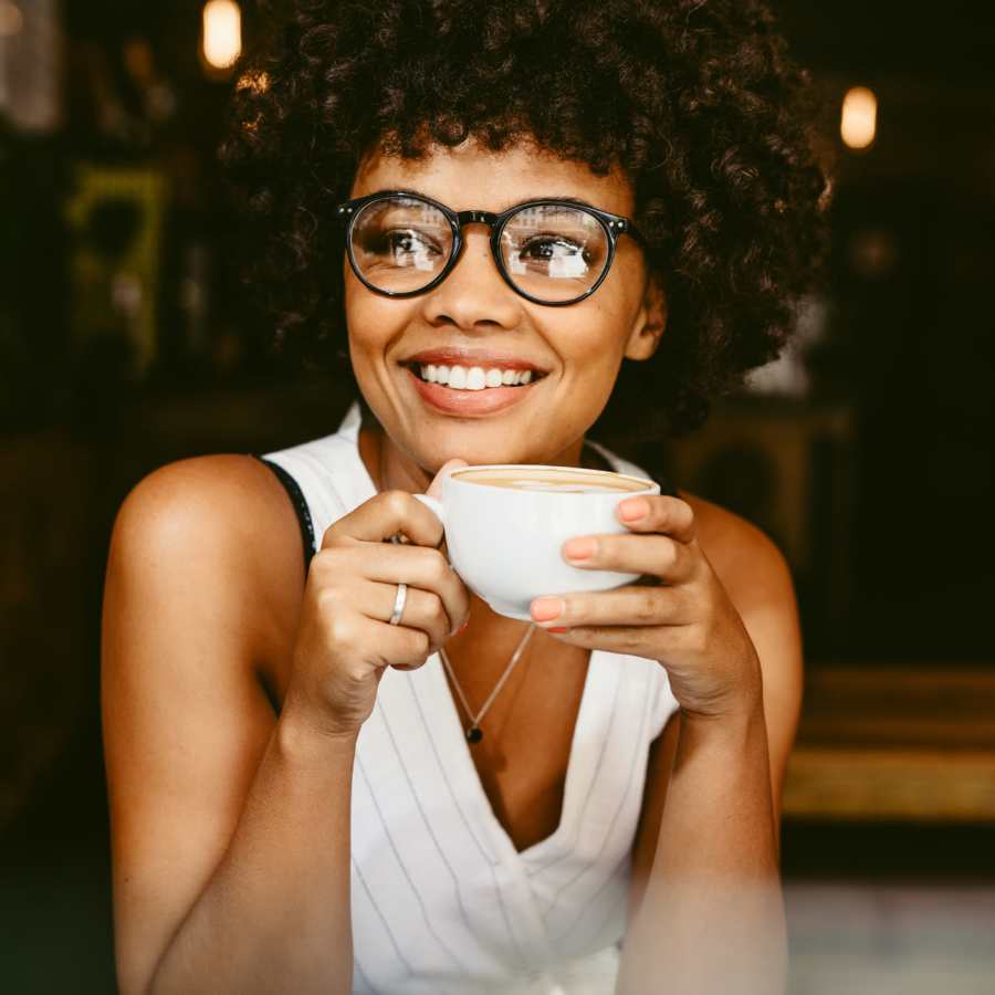 Young woman drinking coffee at Britain Village in Lawrenceville, Georgia