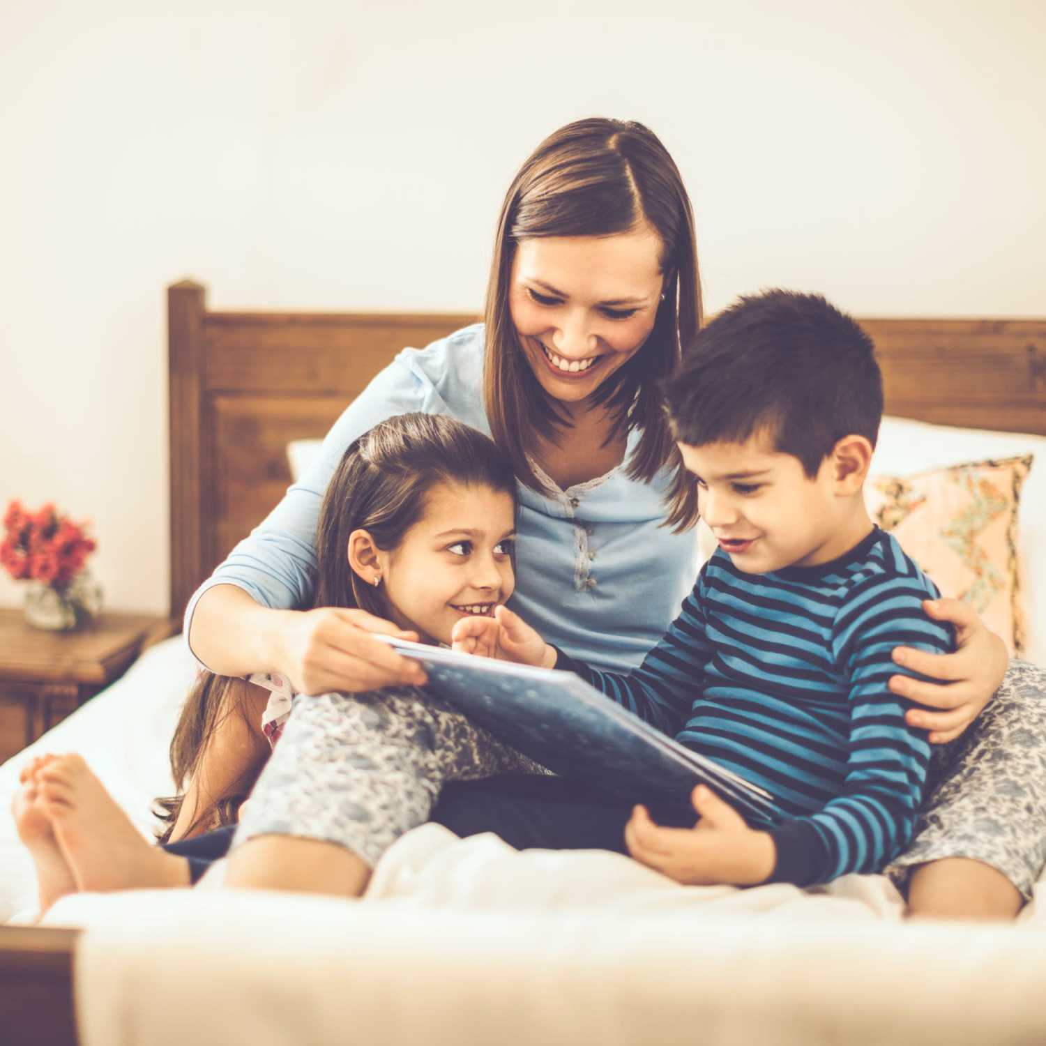 Resident woman with her kids in bedroom at Cypress Point Apartments in Shawnee, Oklahoma