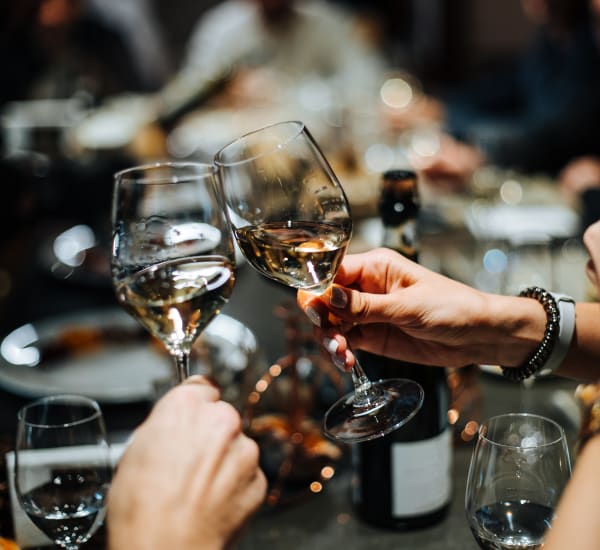 A group of people holding wine glasses near EOS in Orlando, Florida