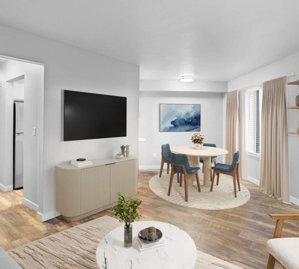 Living room and dining area with wood-style floors at Waterhouse Place in Beaverton, Oregon