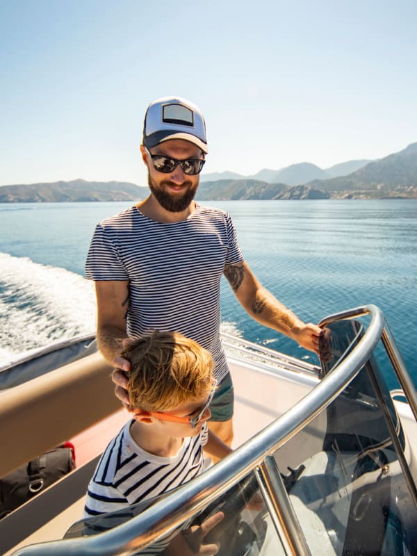 A father and son steering a boat on a lake near modSTORAGE in Laramie, Wyoming