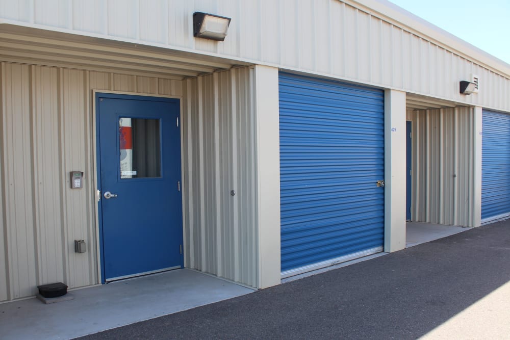 blue door with lights above every outdoor unit at Tolleson Self Storage in Tolleson, Arizona