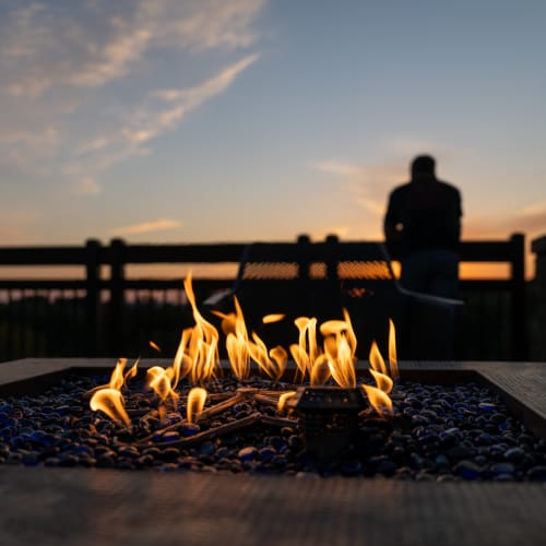 Flames above blue glass stones at Avia Lofts at Maple Road in Amherst, New York