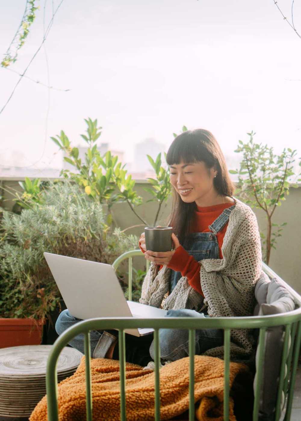 Resident working in her balcony at Palomar Woods in Lexington, Kentucky