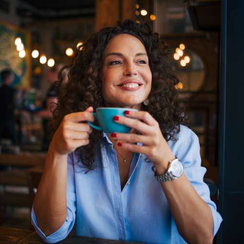 Woman having coffee at a cafe near 30 Metro in Omaha, Nebraska