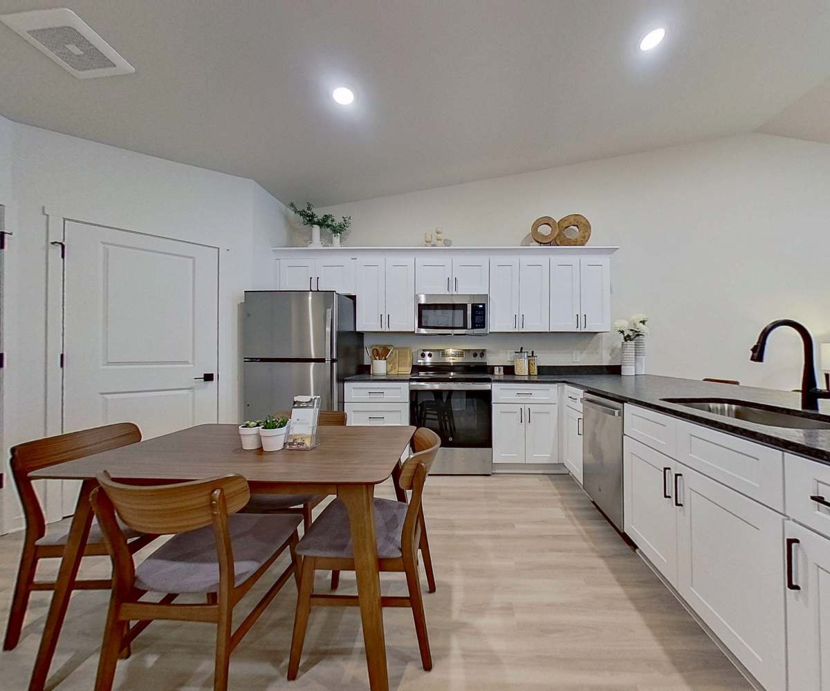 Spacious apartment kitchen with white cabinetry at Arabella Apartments in Independence, Missouri