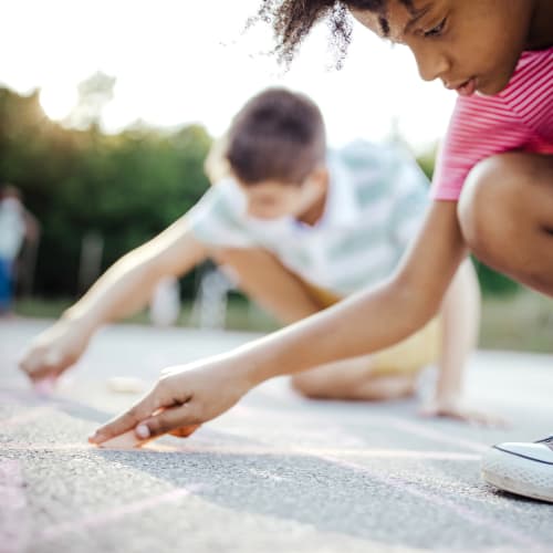 Kids drawing with chalk at Kansas City in Belton, Missouri