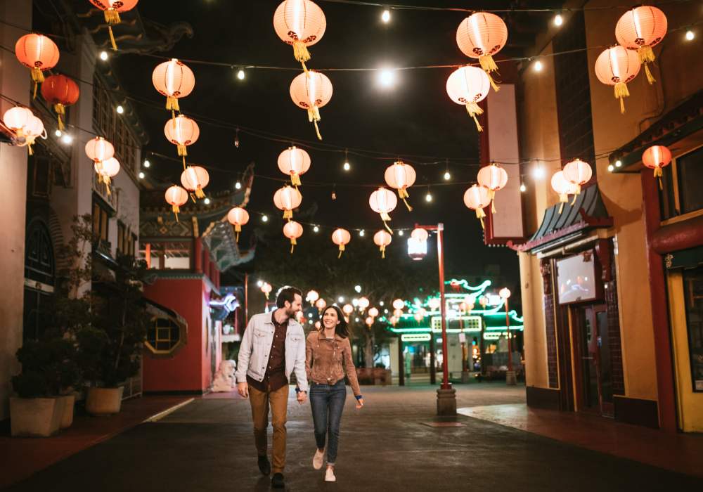 Couple walking on street with a beautiful light at downtown near Villa Del Sol in Sunnyvale, California